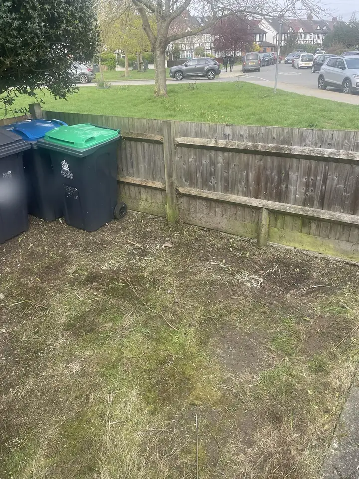 After: Garden waste bags piled by the fence. Cleared.