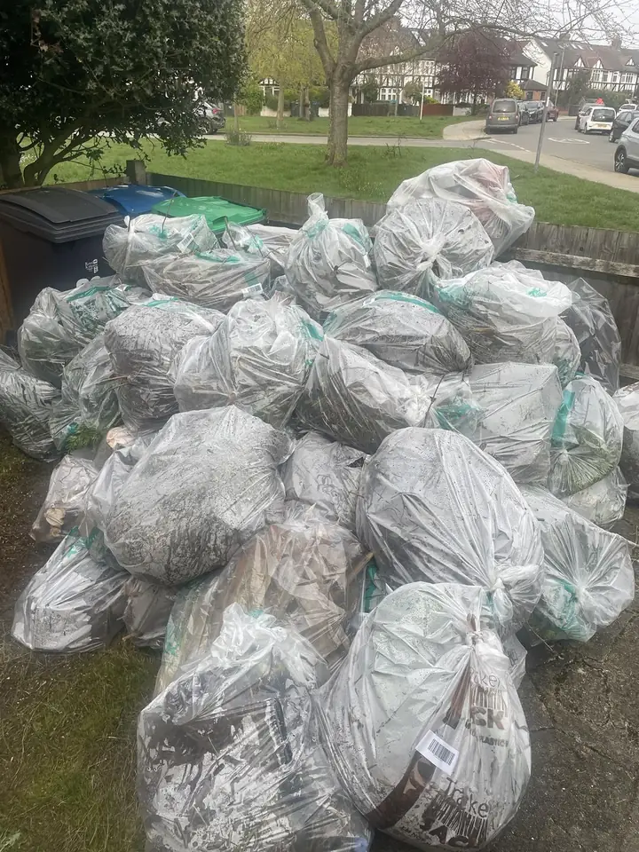 Before: Garden waste bags piled by the fence. Cleared.
